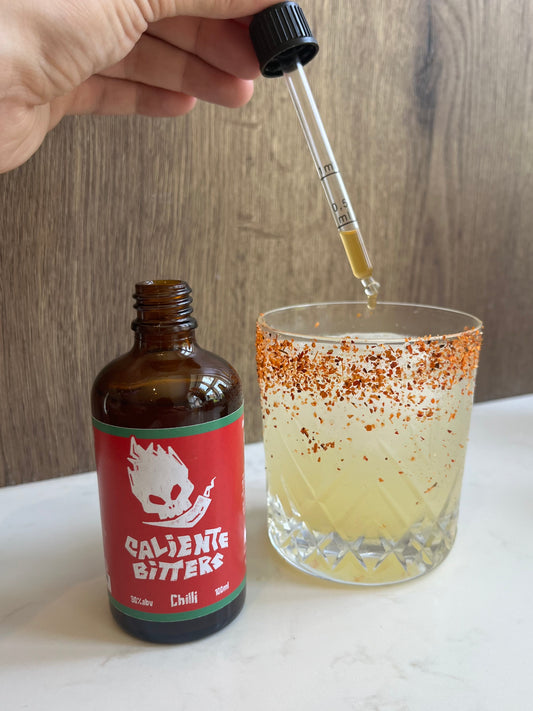 Caliente Bitters Bottle With Dropper In Use